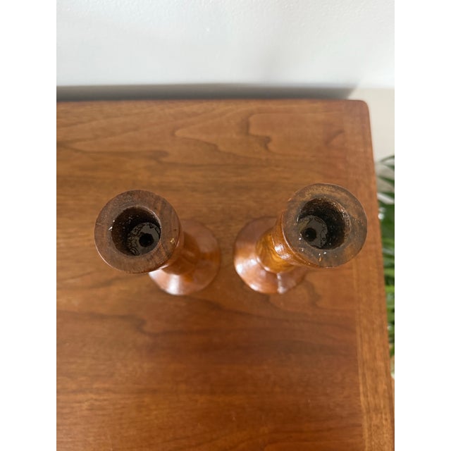 beautiful pair of vintage hand-turned wooden candlesticks featuring warm, rich wood tones and classic sculptural...