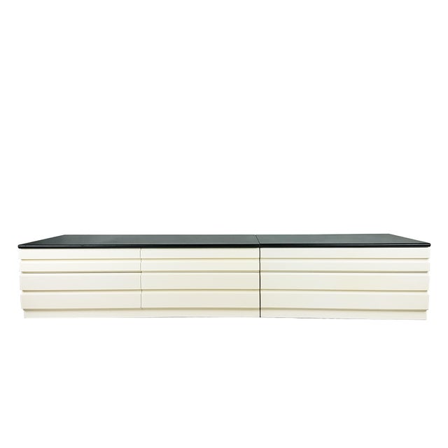 Wooden structure painted in white polyurethane color. Black skai cover on the top (light defects at some corner). Large...