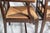 A sturdy pair of stylish early 20th century Dutch wood arm chairs with rush seats. Chairs have a very interesting and...