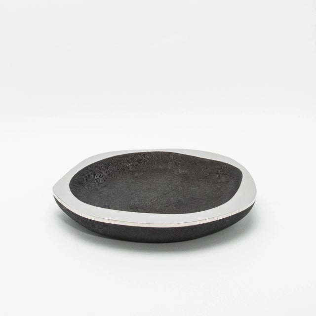 The Lily Bowl in black shagreen with stainless steel details by R&Y Augousti is a masterful blend of elegance and...