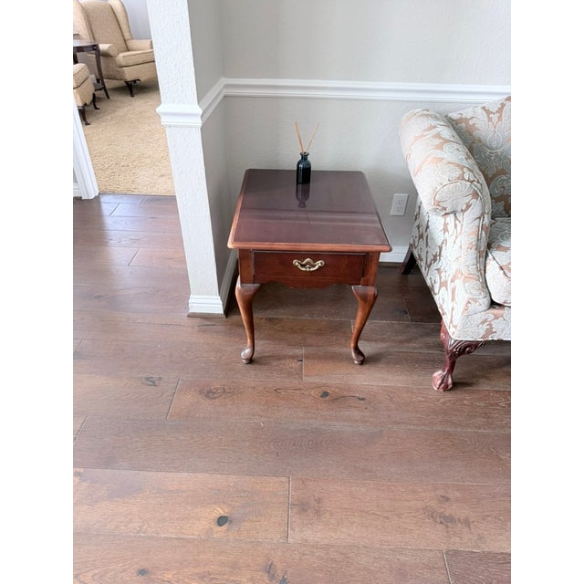 Classic dark mahogany square side tables in the Chippendale tradition, each featuring a single brass-handled drawer and...