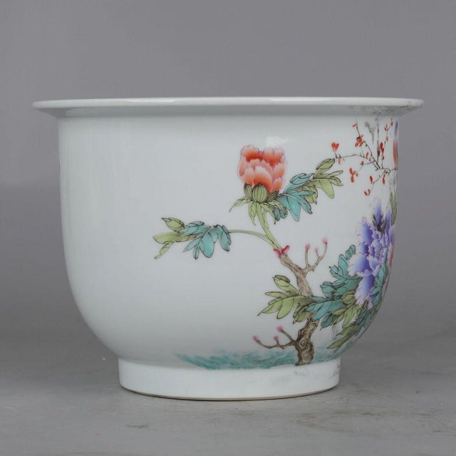 This elegant porcelain planter features a classic silhouette with a flared rim, resting upon a slightly tapered foot. The...