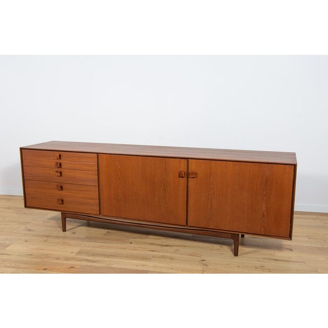 This magnificent mid-century Danish design sideboard credenza was designed by Ib Kofod-Larsen and manufactured by G-Plan...