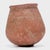 This petite hand-formed vessel bears a richly textured surface of worn red clay slip and dark smoke marks. Likely intended...
