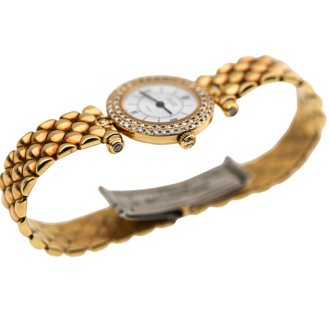 Vintage Van Cleef and Arpels Paris ladies quartz watch in 18K yellow gold featuring a double row diamond bezel and...