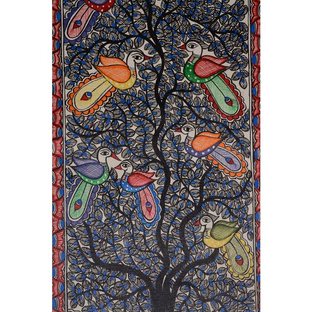 This captivating traditional Madhubani painting depicts a flourishing Tree of Life, its branching canopy filled with...