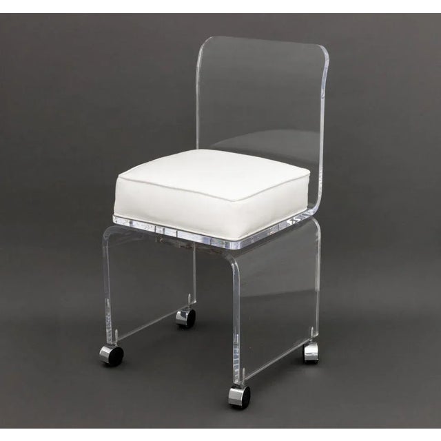 Modern Lucite Swivel Vanity Chair, with white leather cushion on waterfall base and four casters. 32" H x 16" W x 17" D;...