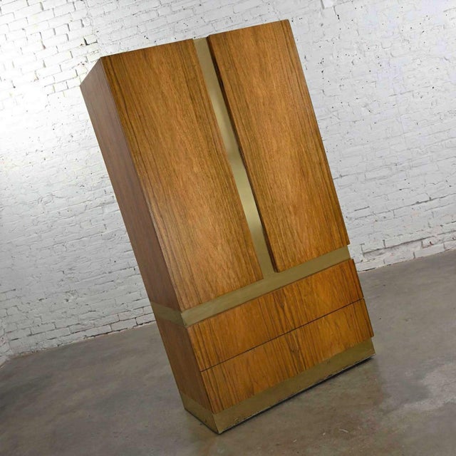 Phenomenal vintage modern rosewood & brass plate wardrobe or chifforobe by Milo Baughman for Thayer Coggin. Comprised of...