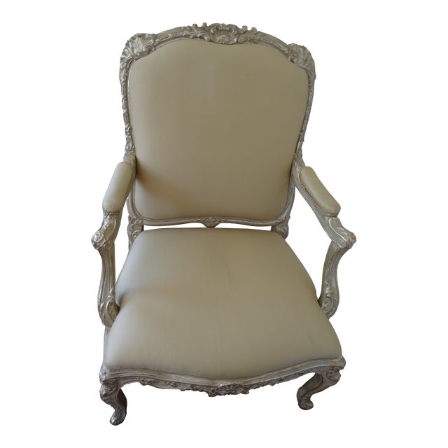 A fabulous Fairchild fauteuil from luxury furniture maker Dennis & Leen. Hand carved frame is finished in a silver gilt....