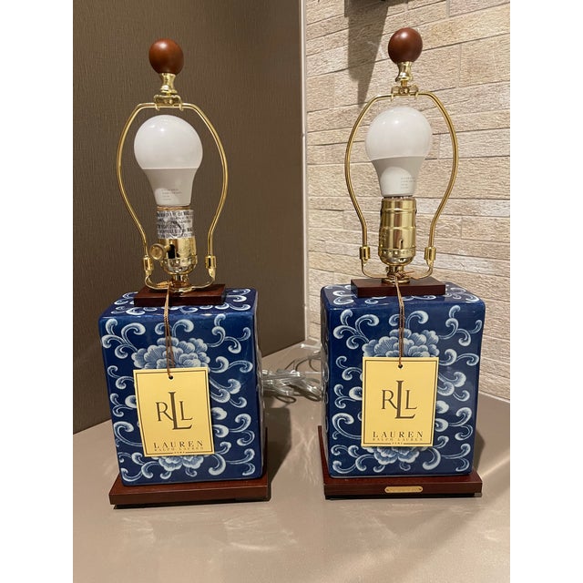 A pristine, matching pair of brand-new-with-tags Lauren Ralph Lauren Home porcelain table lamp. A masterclass in...