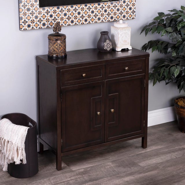 This stylish console cabinet combines Modern minimalism with Eastern design elements. Featuring clean lines and a Coffee...