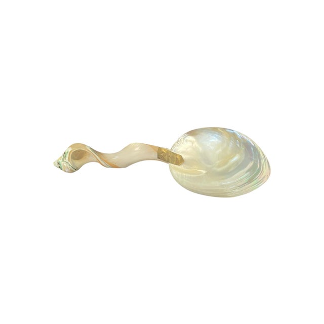 Vintage mid-century sculptural mother-of-pearl caviar serving spoon. This organic modern piece exemplifies Hollywood...