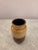 A charming vintage ceramic vase featuring a rich brown drip glaze finish with warm speckled caramel and amber tones. The...