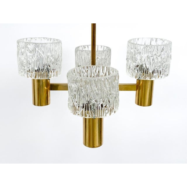 A gorgeous set of 1950's light fixtures by Carl Fagerlund for Orrefors, including a four-arm pendant light and two...