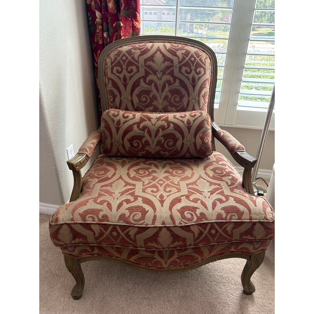 A handsome pair of vintage Homestead House upholstered armchairs combining French Provincial styling with generously...