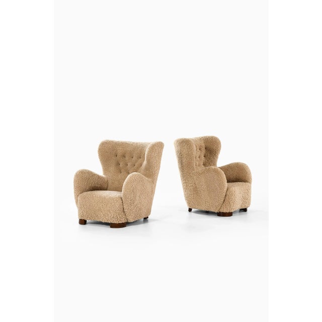 Pair of Easy Chairs in Stained Beech and Lambskin, 1940s Additonal Information: Material: Stained beech and lambskin...
