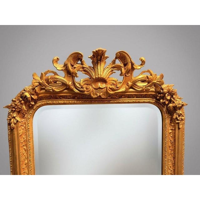 An absolutely stunning French style panel mirror featuring a rich gilt wood and plaster frame with beveled glass. The top...