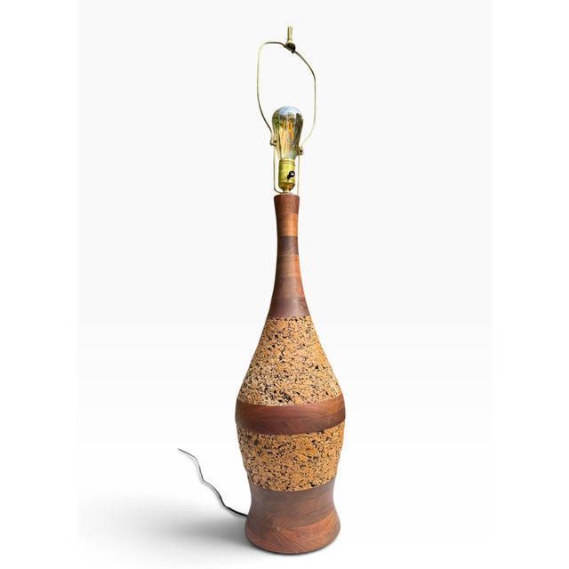 A handsome mid-century table lamp that pairs warm teak with natural cork in alternating bands, a signature 1960s MCM...