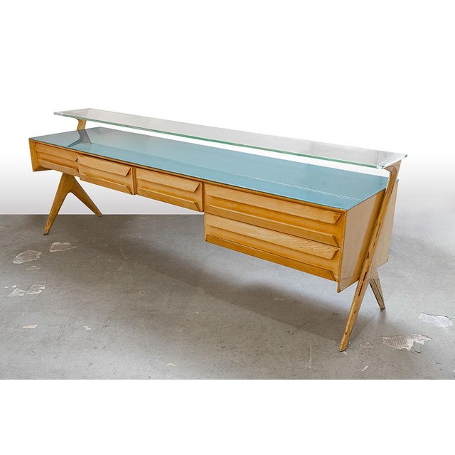 Iconic chest of drawers designed by Vittorio Dassi in the late 1950s in light wood and glass. The clear glass top features...