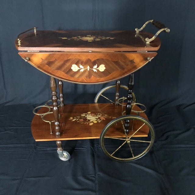 Beautiful early 20th Century Italian bar cart with beautiful intricate marquetry throughout. Cart has two drop leaves for...