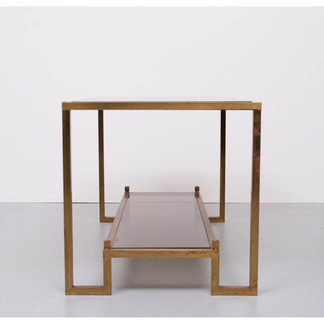 Superb Bronze coffee table. Love the u shaped legs comes with thick smoked Glass tops . Beautiful red Gold and Green Patine