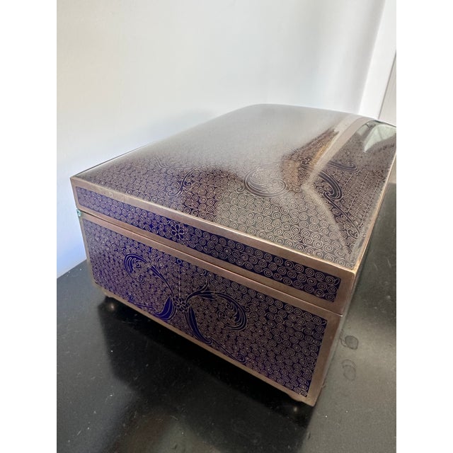 Late 19th Century Chinese Blue Cloisonné Enamel Box on brass ball feet. The box is lined in a dark wood. No visible...