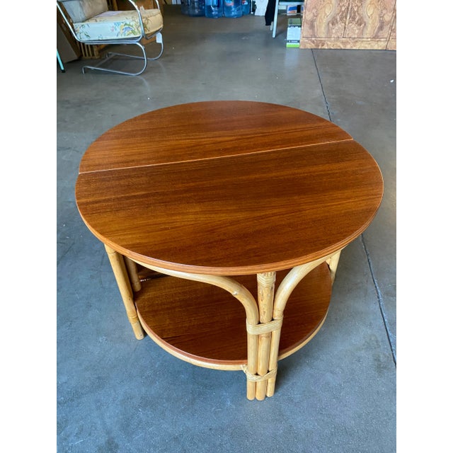 Rare pair of half-round rattan coffee tables, the Pair both feature a half circle design with a rattan base and solid...