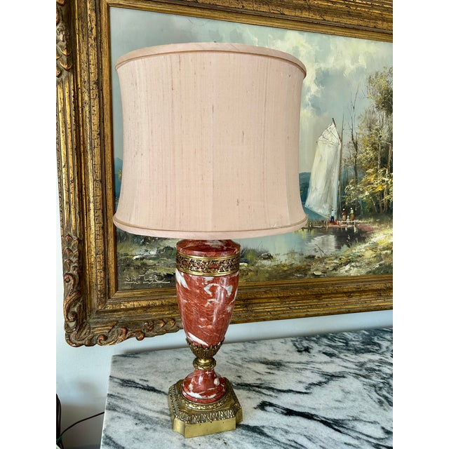 Striking Louis XVI / Neoclassical–style table lamp featuring featuring a rouge (red) marble body with dramatic white...