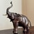 Vintage mid-century modern elephant sculpture featuring a rich bronze-tone finish with polished brass tusks. This striking...