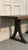Rustic industrial chestnut wood table, crafted from a single thick plank and supported by sturdy cast iron legs. A piece...