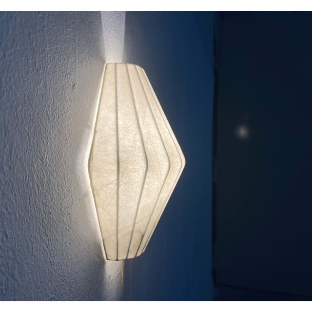 Mid-Century Modern Cocoon wall lamp by the German manufacturer Goldkant, designed by Friedel Wauer in the 1960s. The lamp...