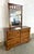 This cherry dresser offers six spacious drawers arranged in two columns, accented with matching wooden knobs and warm,...