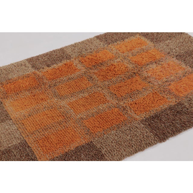 Hand-knotted in lush, high-pile wool in Sweden circa 1960-1970, this 5x7 vintage Swedish Rya rug is a bold new addition to...