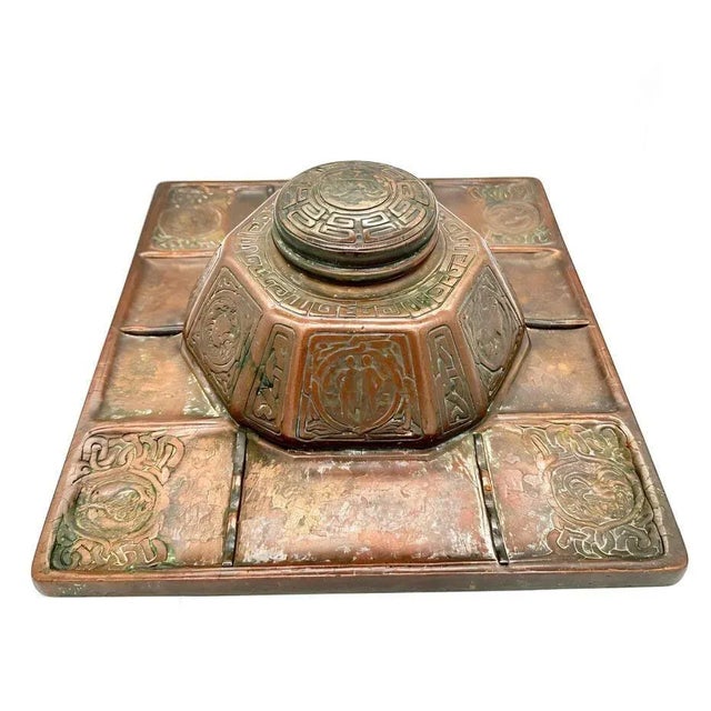 Tiffany Studios number 1078 bronze Art Nouveau "Zodiac" pattern inkwell. This bronze inkwell is permanently mounted on a...