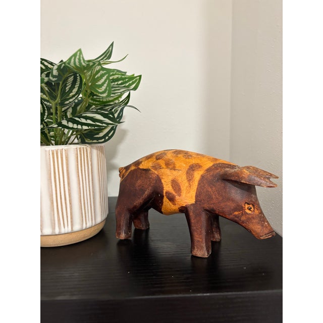 Charming vintage hand-carved wooden pig sculpture with a wonderfully primitive folk art character. The figure is carved...