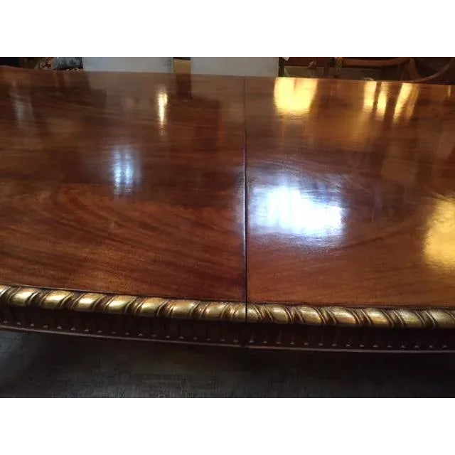 English mahogany & giltwood carved dining table. Made in the 1900s.