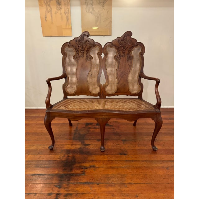 French provincial style, with double caned settee. Caned seating portion was recently redone by previous owner.