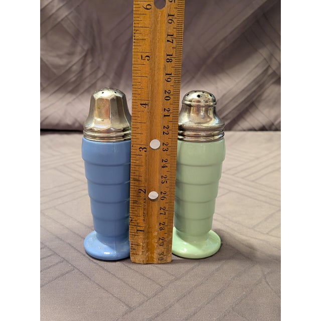 A beautiful, highly collectible pair of vintage salt and pepper shakers from the 1940s, manufactured by the renowned...