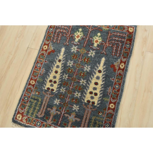 A traditional tribal Heriz rug hand-knotted with an all-wool pile on a cotton foundation. This oriental rug features a...