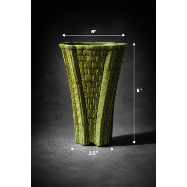 A striking vintage ceramic vase featuring a sculptural fluted form and richly textured basketweave relief, finished in a...