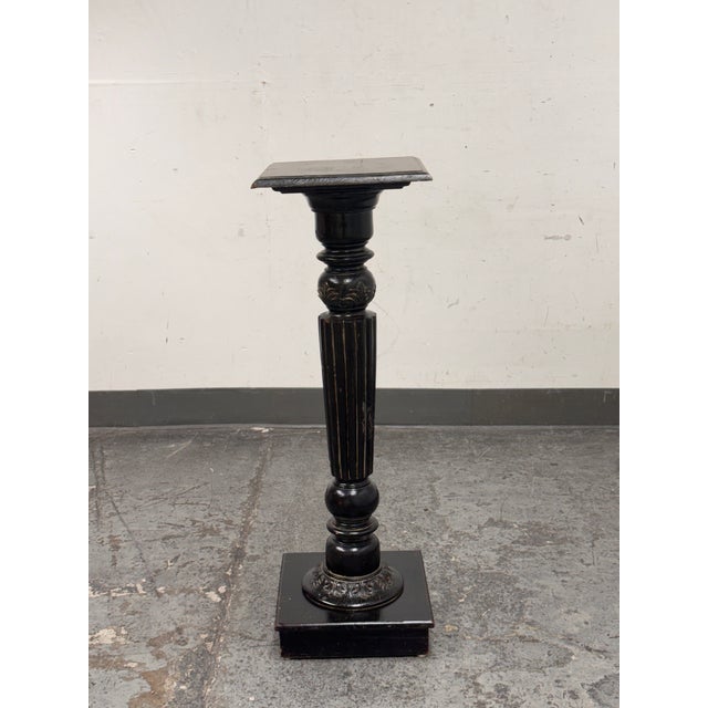 Design Plus Gallery presents a Vintage Wood Distressed Pedestal Table. This tall pedestal table showcases a square top...