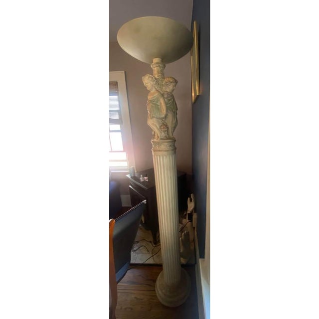 Stunning and unique floor lamp in a Neoclassical style. Features a tall, fluted column base adorned with charming putti...