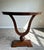Elegant pair of J. Alexander ‘Sardinia’ console tables featuring dramatic neoclassical lyre-form bases and demi-lune tops...