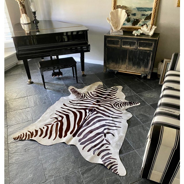 Vintage natural Brazilian cowhide with a black/brown and white zebra stencil. Suitable in different periods/styles of...