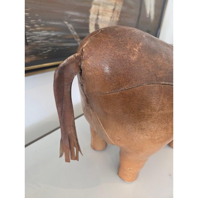 A striking and characterful vintage rhinoceros sculpture, beautifully handcrafted in rich brown leather. The piece...
