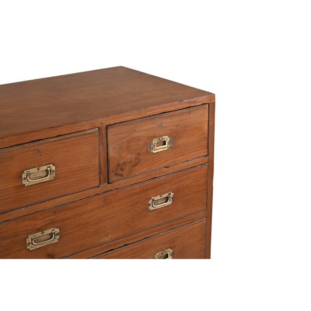 This Antique Anglo-Indian Teakwood Campaign Chest of Drawers is handcrafted from solid teakwood, featuring a classic...