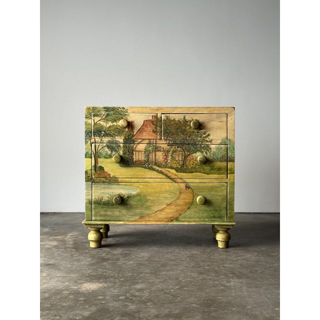 A storybook English cottage unfolds across every surface of this one-of-a-kind antique four-drawer chest, painted in soft...