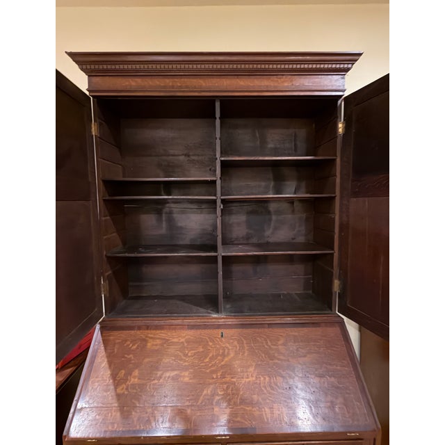 Handsome antique slant-front secretary desk dating to the turn of the 20th century, featuring a paneled upper cabinet with...