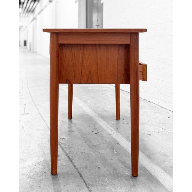 Desk produced by vi-ma møbler in denmark during the 1960s. executed with two drawers featuring integrated carved handles...