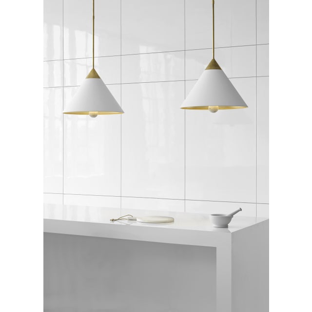 Cleo Pendant in Antique-Burnished Brass and Antique White with Frosted Acrylic Designer: Kelly Wearstler Fixture Height:...